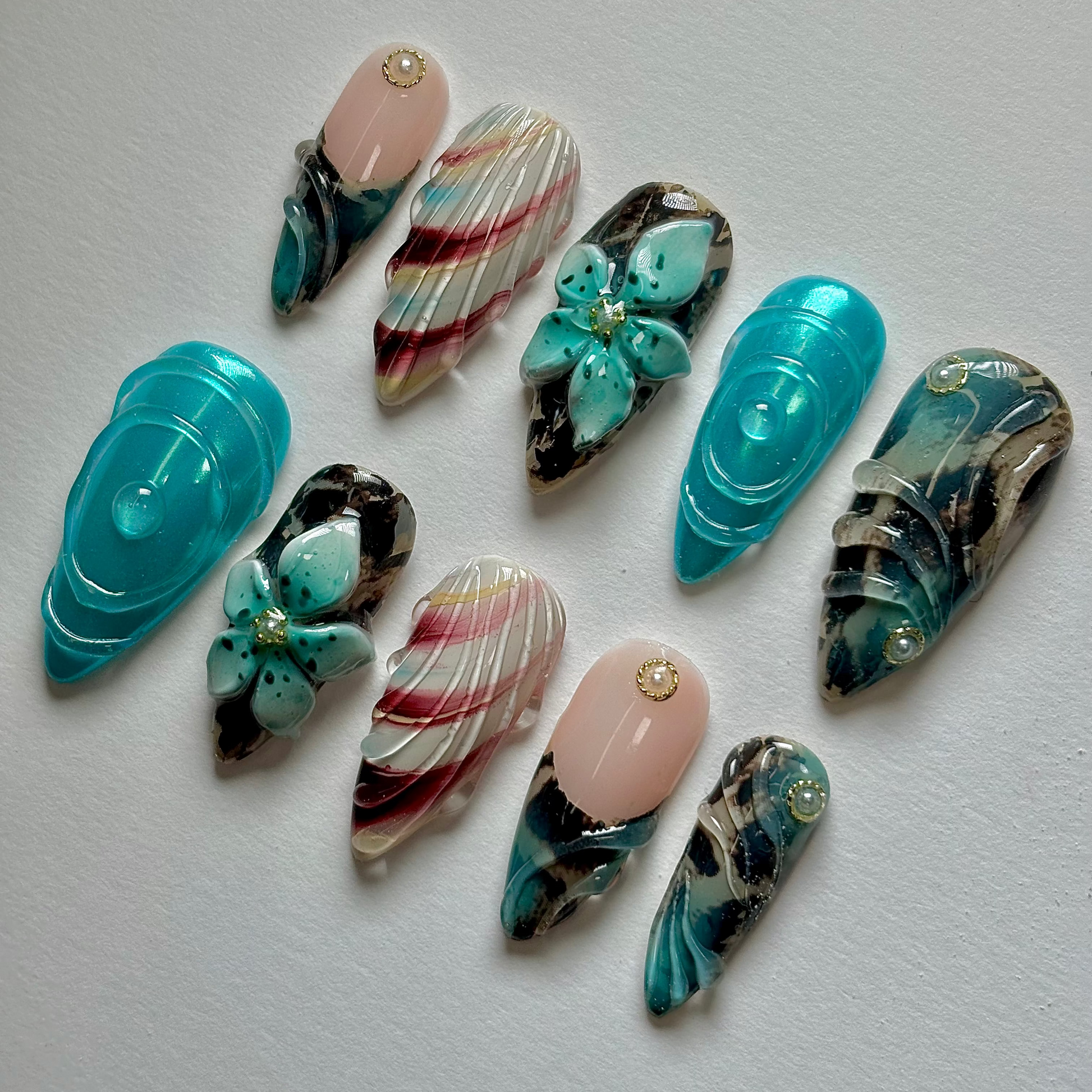 Collection of decorative nail art designs on a plain background