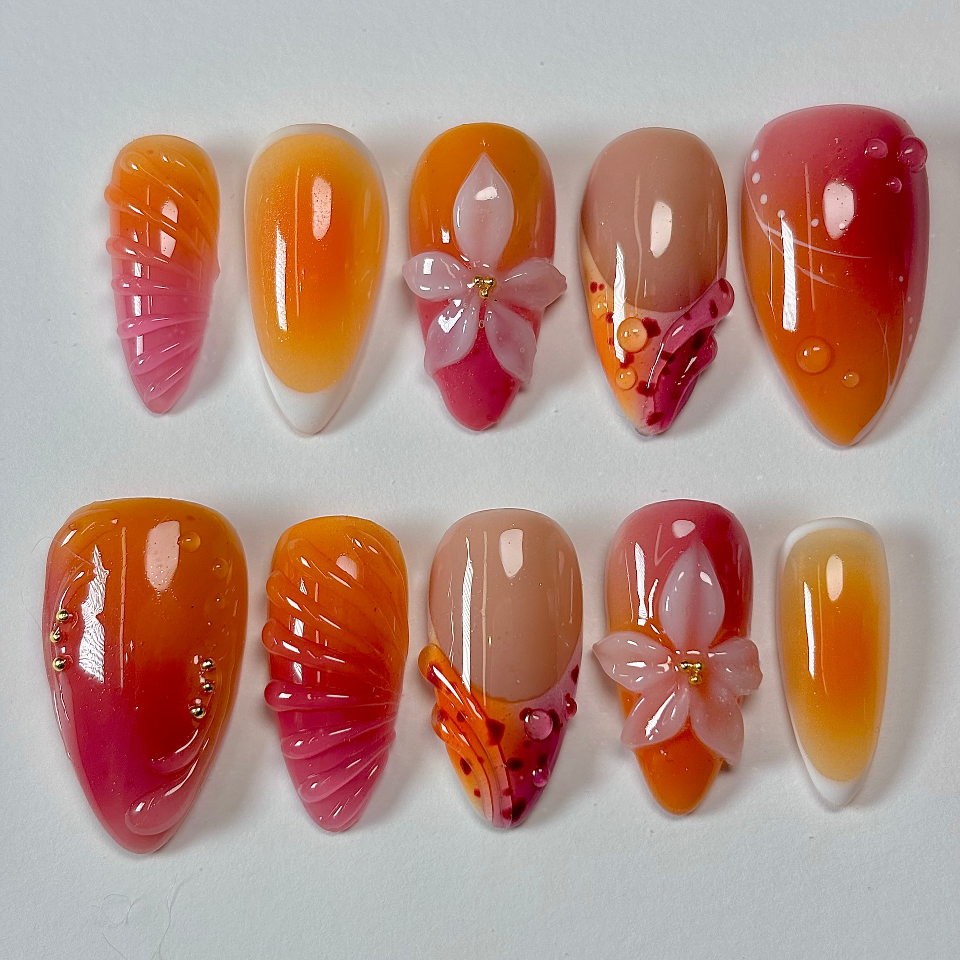 Set of nail art designs with gradient colors and butterfly decorations on a white background